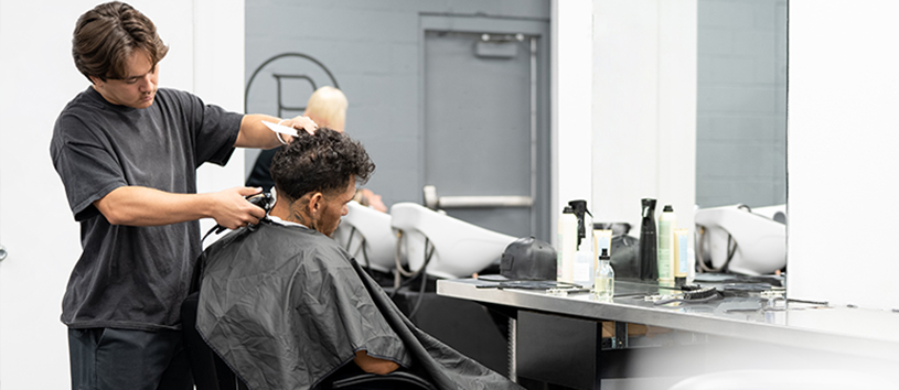 Barber cutting mans hair