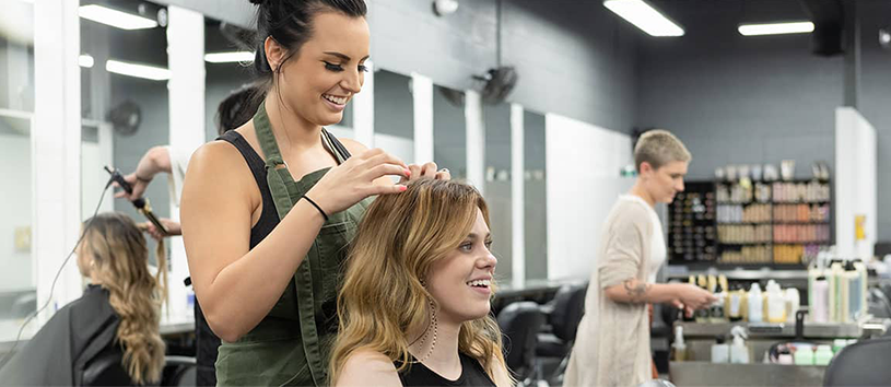 Women getting her hair done by stylist.